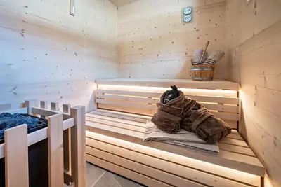 a sauna with a dog sitting on a blanket in it at MULIN Appartements in Valles