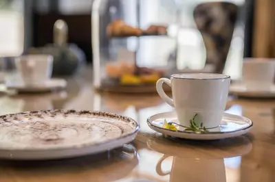 a coffee cup and a plate on a table at MULIN Appartements in Valles