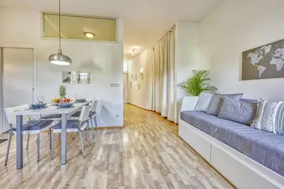 a living room with a couch and a table at HOMESTWENTY3 - Home four in Caldaro