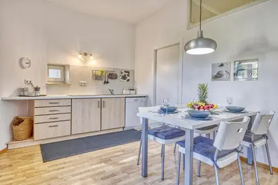 a kitchen with a table and chairs in a room at HOMESTWENTY3 - Home four in Caldaro