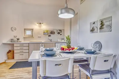 a dining room with a white table and chairs at HOMESTWENTY3 - Home four in Caldaro
