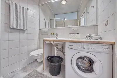 a bathroom with a washing machine and a sink at HOMESTWENTY3 - Home four in Caldaro