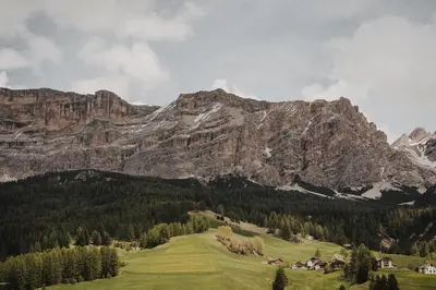a mountain range with a village in the foreground at Larix Lodge in La Villa