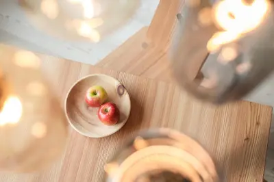 two apples in a bowl on a table at Larix Lodge in La Villa