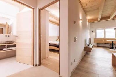 a room with a door leading to a bedroom at Baumgartnerhof Sauvigon in Cortaccia