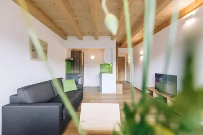 a living room with a couch and a table at Baumgartnerhof Sauvigon in Cortaccia