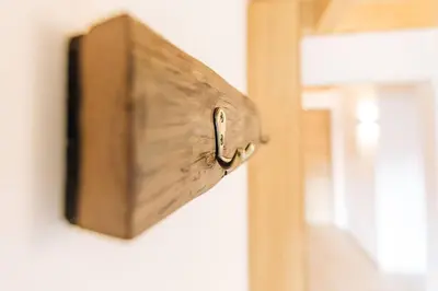 a wooden switch on a wall next to a window at Baumgartnerhof Sauvigon in Cortaccia