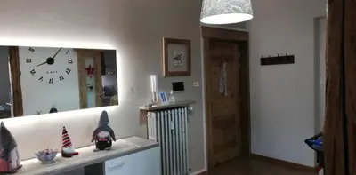a room with a mirror and a clock on the wall at Appartamento 