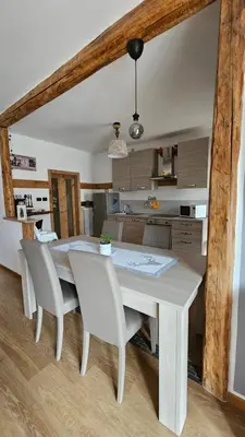a white dining room table and chairs in a kitchen at Appartamento 