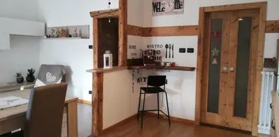 a room with a desk and a table with a chair at Appartamento 