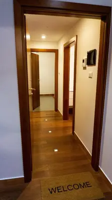 a hallway leading to a room with a door at Meran/o Centro Guest House in Merano