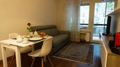 a living room with a table and a couch at Meran/o Centro Guest House in Merano