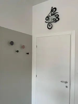 a room with white walls and a door with stickers on it at CASA VITTORIA - SIEGESHAUS in Bolzano