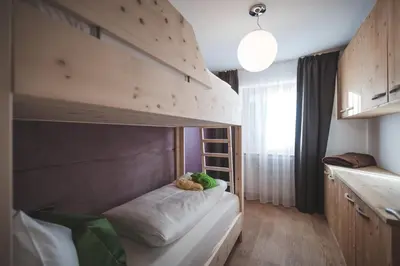 a bedroom with a bunk bed in a room at Dolce Vita Apartment in Valdaora