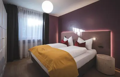 a bedroom with a large bed with a yellow blanket on it at Dolce Vita Apartment in Valdaora