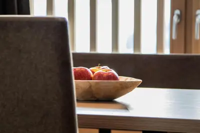 a bowl of apples sitting on a table at Niciora in Badia