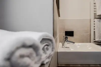 a bathroom with a sink and a toilet and a sink at Niciora in Badia