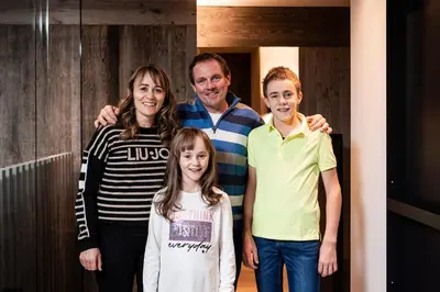 a family posing for a picture in a hallway at Surega - Idyllic Farmhouse in San Cassiano