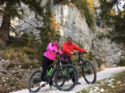 a man and a woman riding bikes on a trail at Surega - Idyllic Farmhouse in San Cassiano