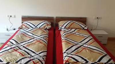 a pair of beds in a room at Rosengarten Apartments in Bolzano