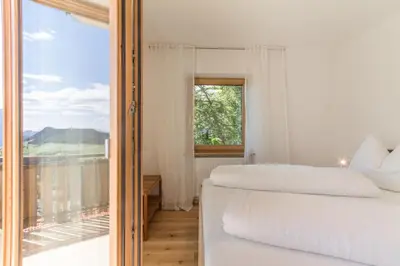 a bedroom with two beds and a large window at Apartment La Brunella in Laion