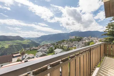 a balcony with a view of a town and mountains at Apartment La Brunella in Laion