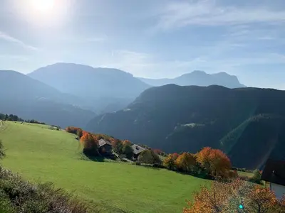 a green field with mountains in the background at Apartment La Brunella in Laion