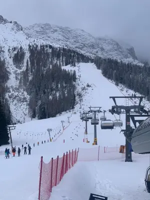 a group of people on a ski lift in the snow at SUITE25 GOLFHOTEL in Carezza al Lago