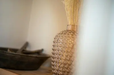 a glass vase sitting on a table next to a bowl at Avista Apartments Sky in Merano