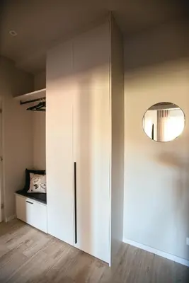 a bedroom with a bed and a mirror on the wall at Avista Apartments Sky in Merano