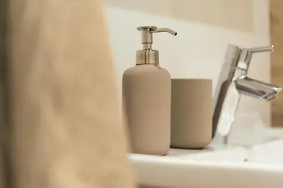 a bottle of soap is sitting on a sink at Avista Apartments Sky in Merano
