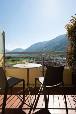 a table and chairs on a balcony with a view at Avista Apartments Sky in Merano