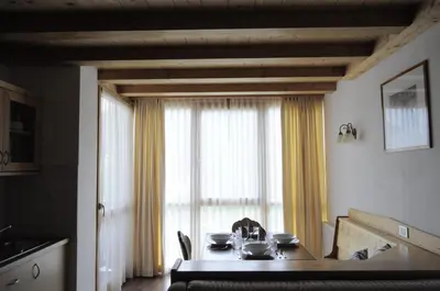 a kitchen with a table with dishes on it at Apartments Etruska in Santa Cristina in Val Gardena