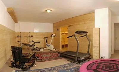 a gym with several exercise bikes in a room at Apartments Etruska in Santa Cristina in Val Gardena