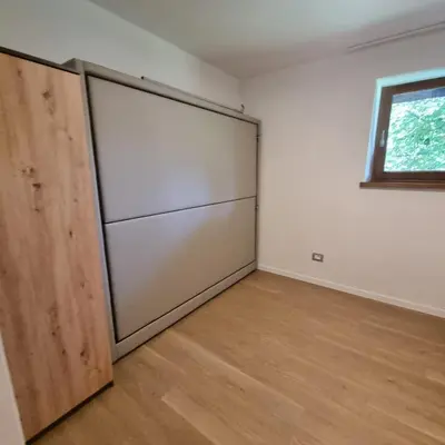 a room with two sliding doors and a window at Casa Tura San Vigilio in San Vigilio Di Marebbe