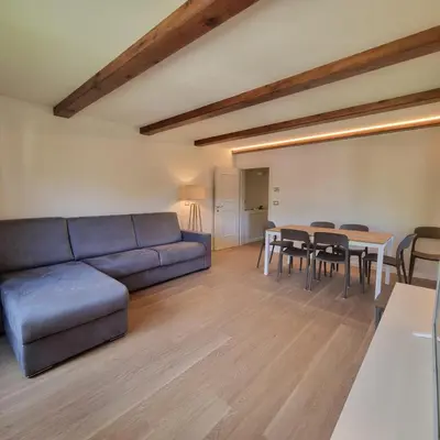 a living room with a couch and a table at Casa Tura San Vigilio in San Vigilio Di Marebbe