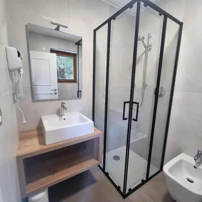 a bathroom with a glass shower and a sink at Casa Tura San Vigilio in San Vigilio Di Marebbe
