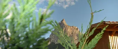 a building with a mountain in the background at Garni Karlegger in Siusi
