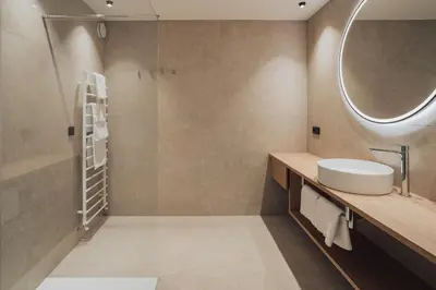 a bathroom with a sink and a mirror at Hotel Lisetta in Tirolo