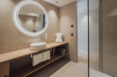 a bathroom with a sink and a mirror at Hotel Lisetta in Tirolo