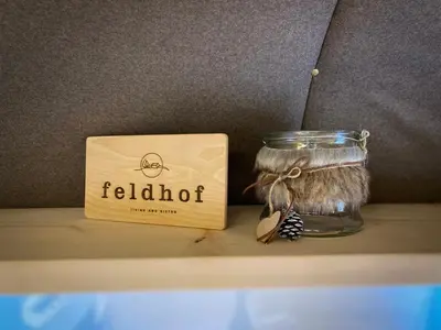 a jar of featherilot next to a box on a shelf at Apparthotel Feldhof - Living and Bistro in Nova Ponente