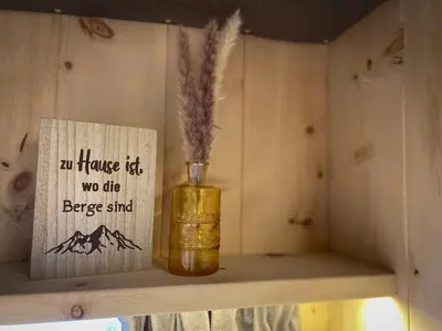a bottle of honey sitting on a shelf with a sign at Apparthotel Feldhof - Living and Bistro in Nova Ponente