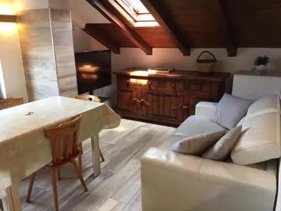 a living room with a couch and a table at La Mansarda di Sabina. in Fiera di Primiero
