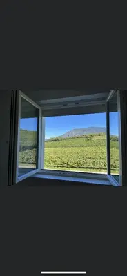 an open window with a view of a field at Azalea in Cornaiano