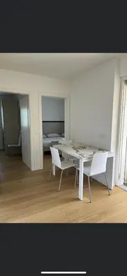 a white room with a table and two white chairs at Azalea in Cornaiano