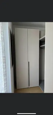 a white cupboard with a refrigerator in a room at Azalea in Cornaiano