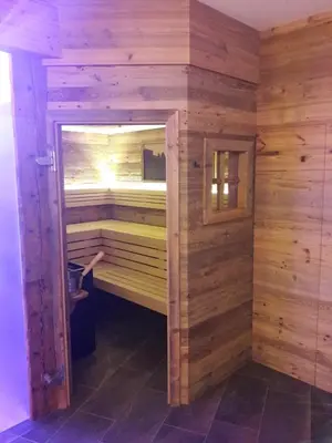 an empty sauna with a door open in a room at Radauerhof in Castelrotto