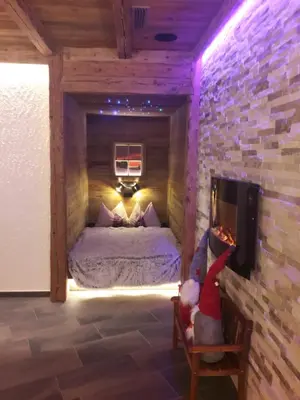 a bedroom with a bed in a brick wall at Radauerhof in Castelrotto