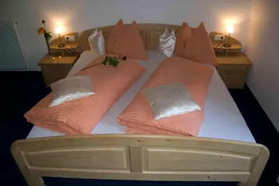 a large bed with pillows on top of it at Radauerhof in Castelrotto