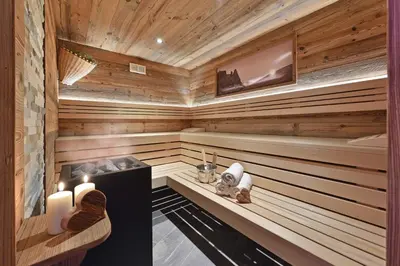 a sauna with two candles and two towels at Radauerhof in Castelrotto